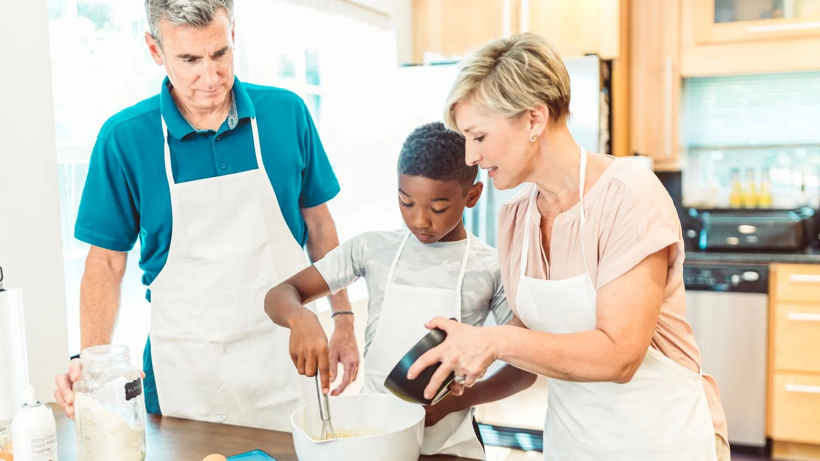 A family cooking together in a bright kitchen