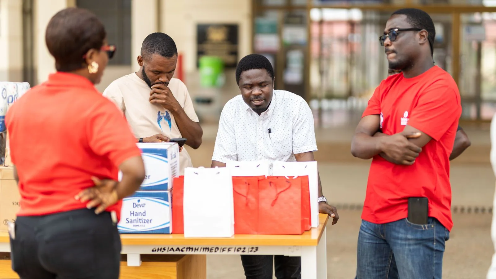 Volunteers distribute materials at a local event.