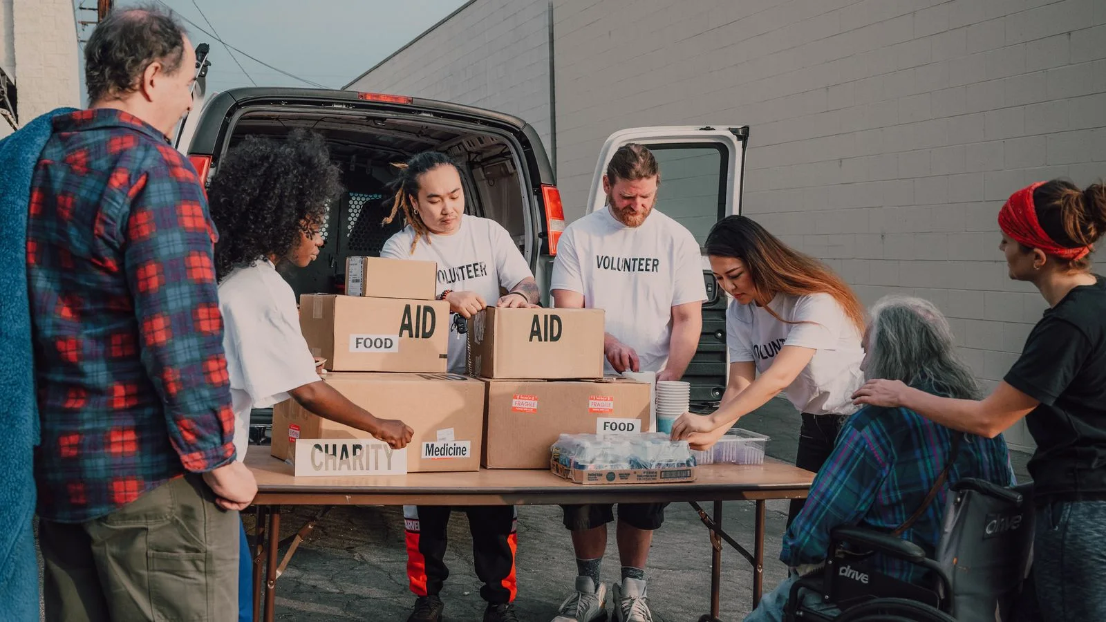 Volunteers stand together and help during a common activity.