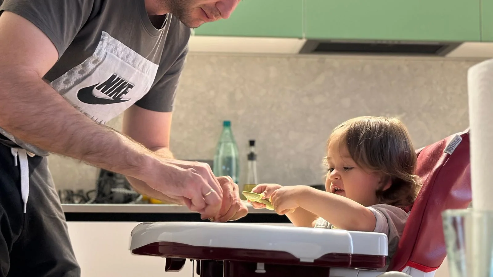 A father and child preparing a meal together in the kitchen