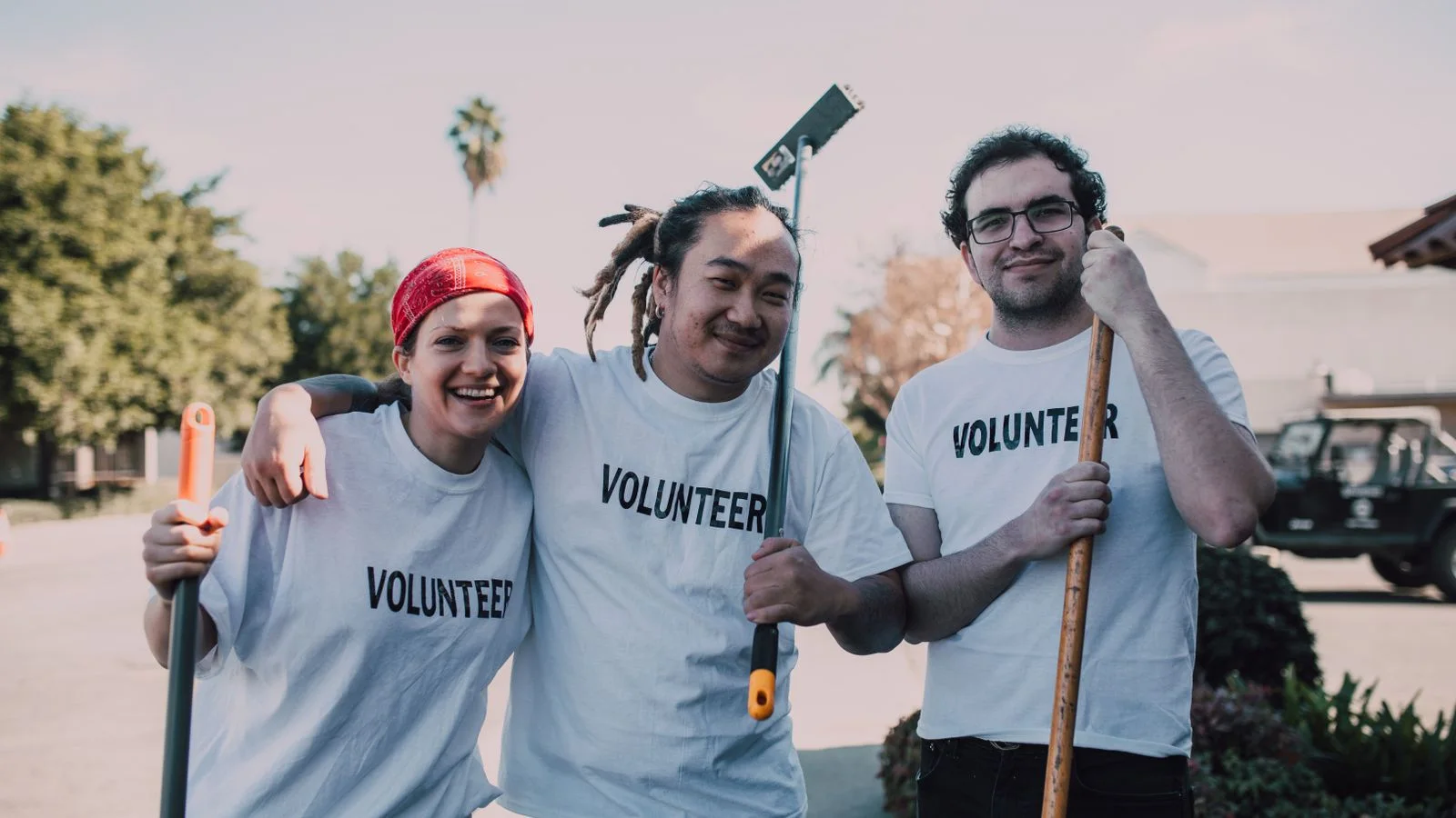 Young volunteers in white shirts working together at an event